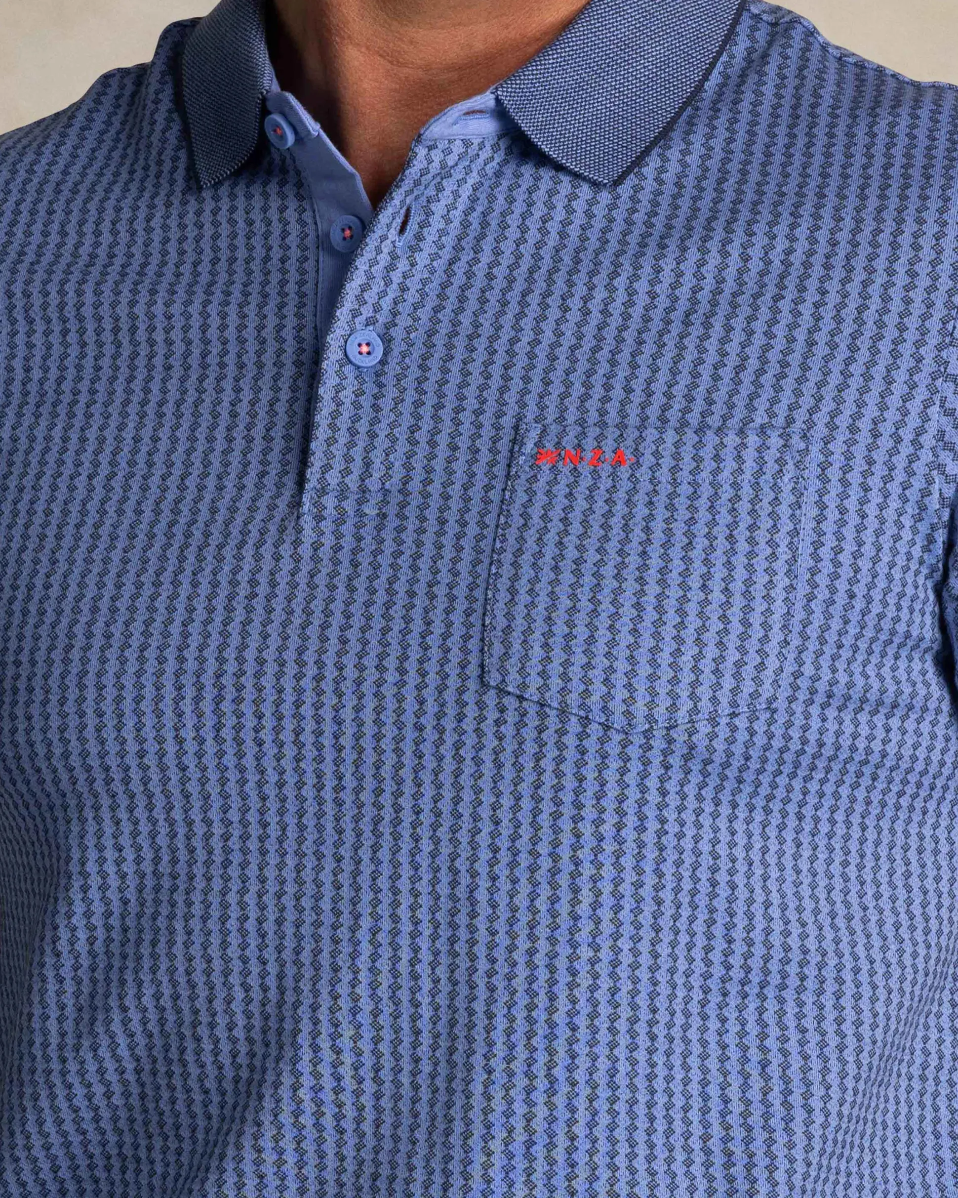 Blue polo with small white stripe