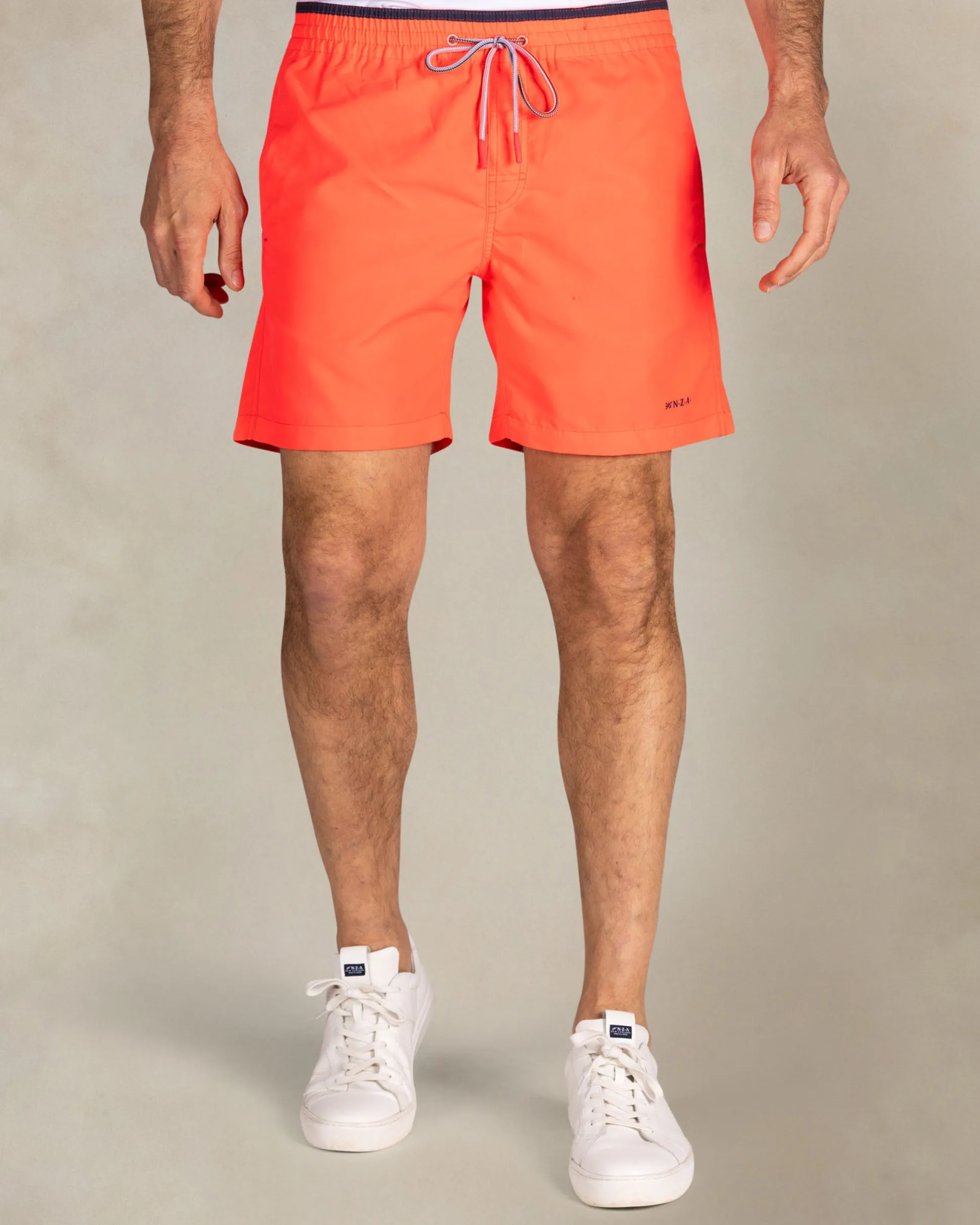 Bright red swim shorts with navy details
