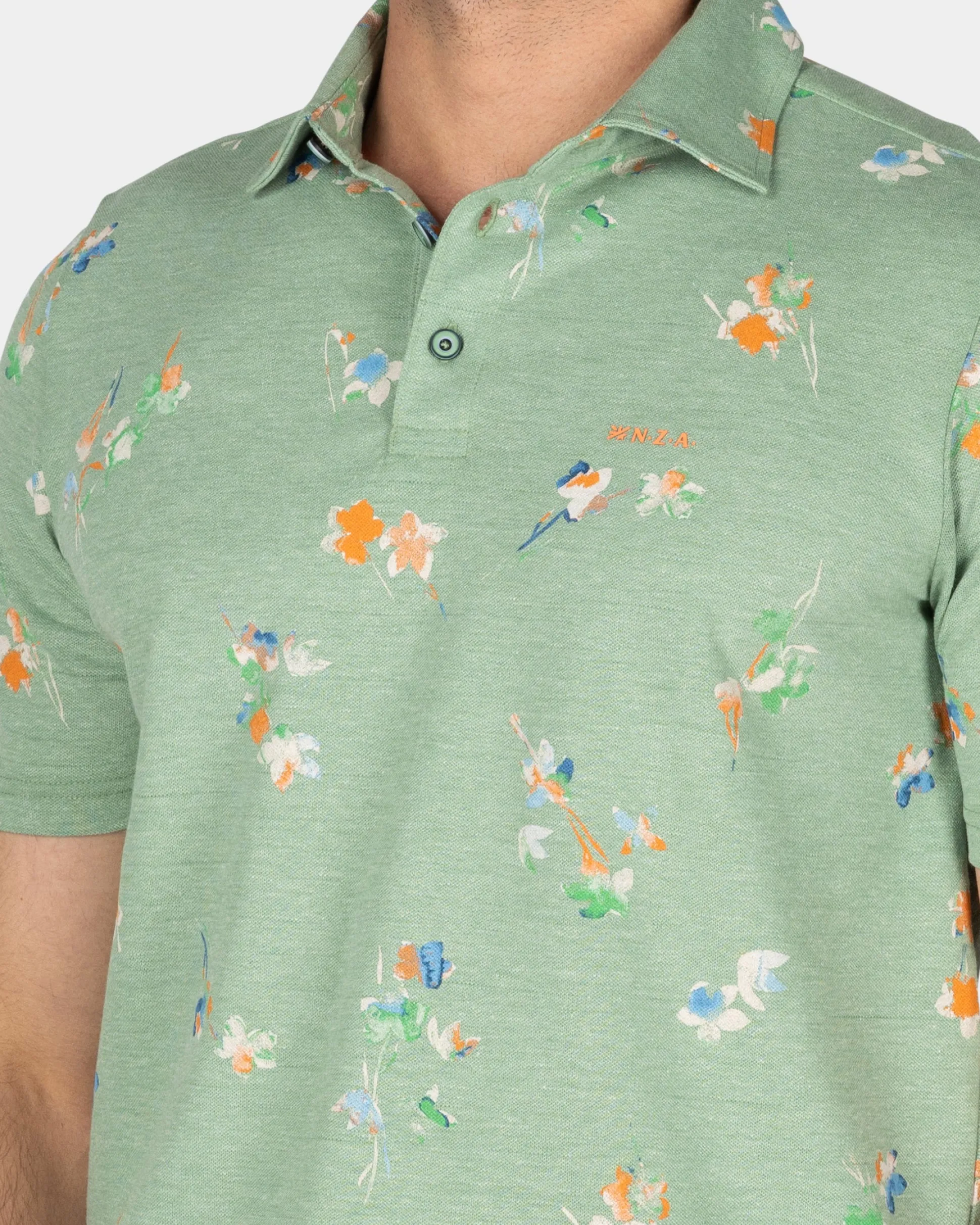 Green polo shirt with leaf print