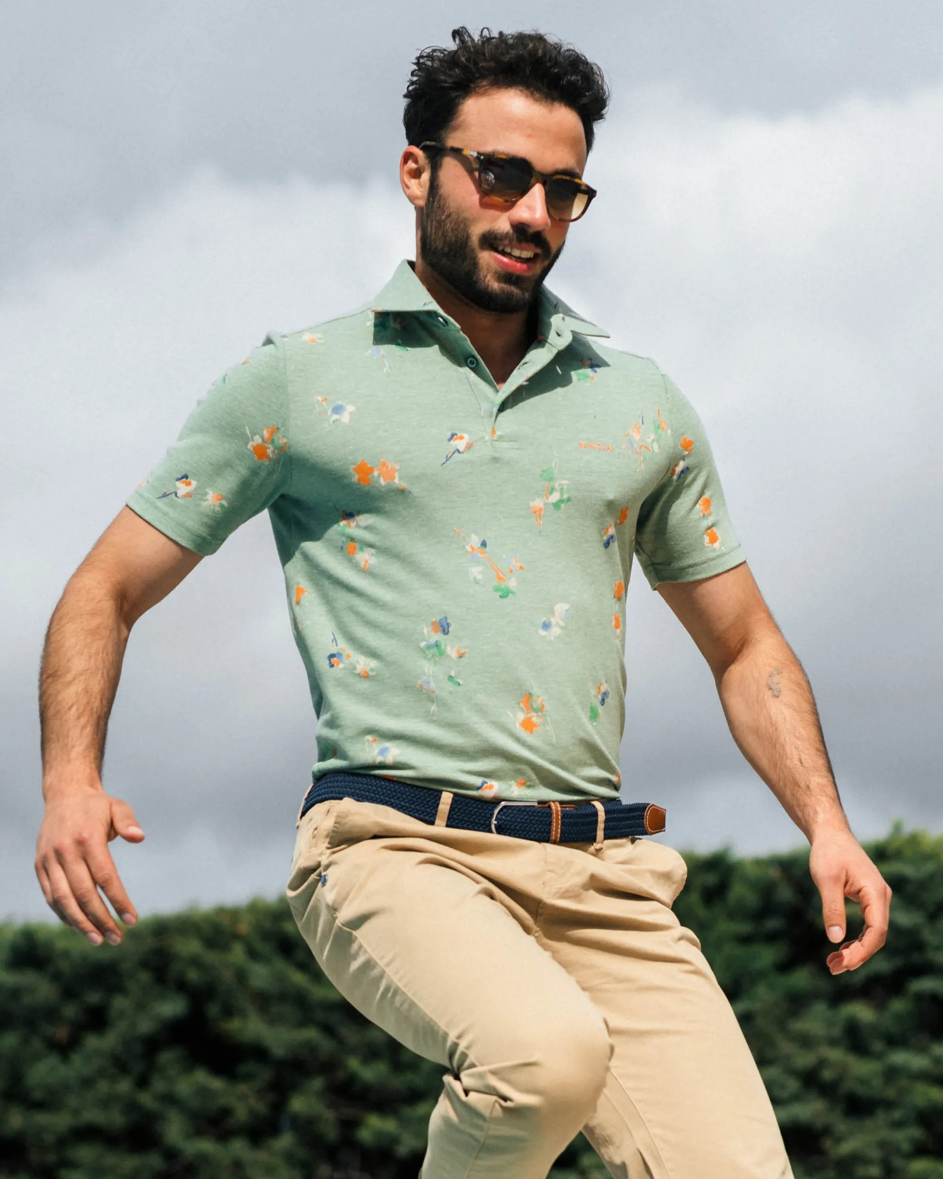 Green polo shirt with leaf print